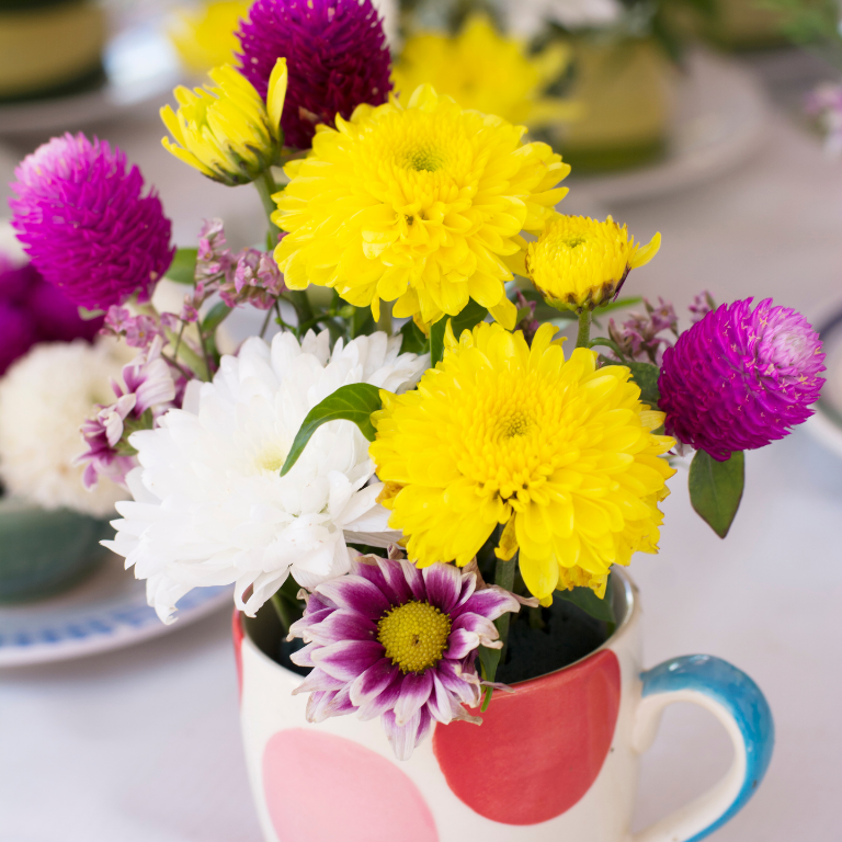 Colorful coffee mug filled with flowers