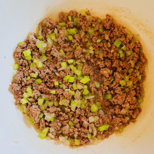 Ground beef browning with celery and onions