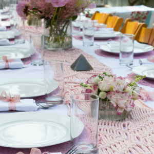 Bridal shower table set with white plates and pink decorations