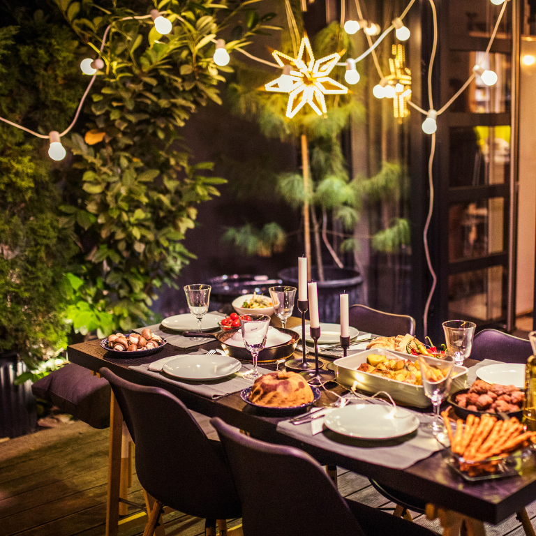 Outdoor dinner table with party lights